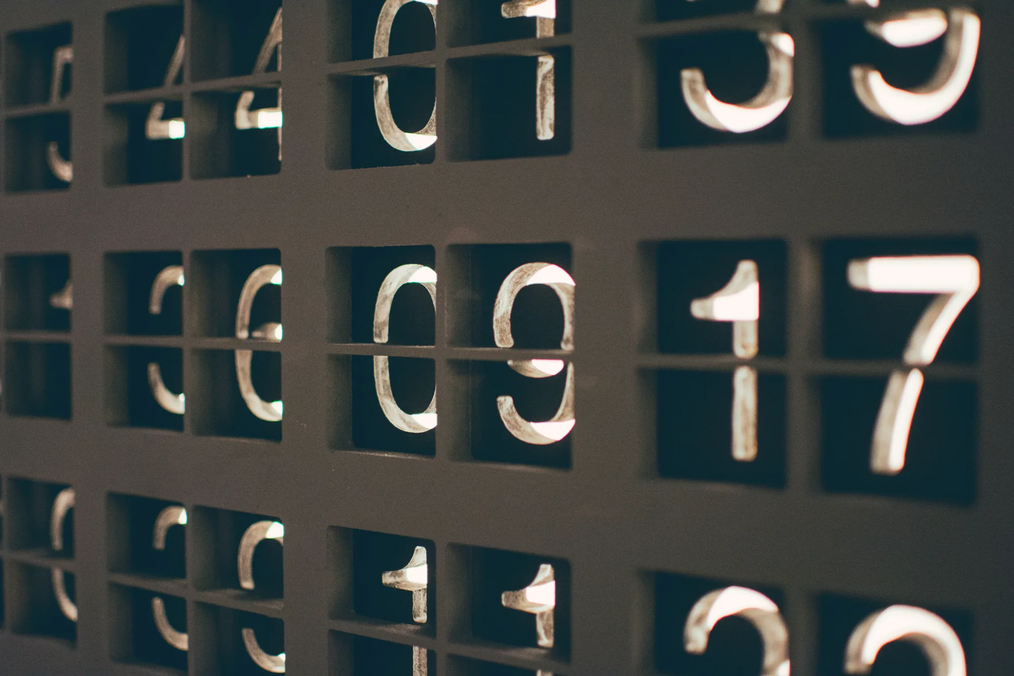 Numbers in metal type arranged in a grid of type case compartments